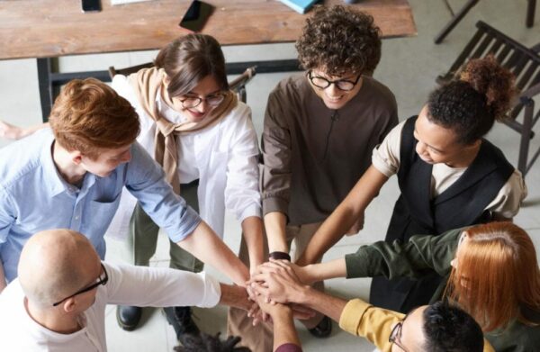 A group of co-workers doing a team huddle