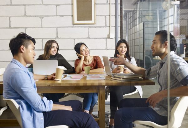 a group of working asians having a discussion