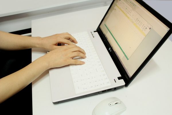 a woman doing data entry work on her laptop