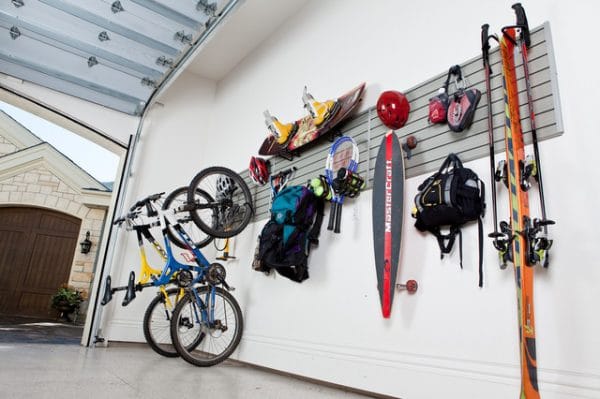 sports equipment on a wall rack inside a garage
