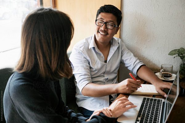 a man and a woman discussing about work