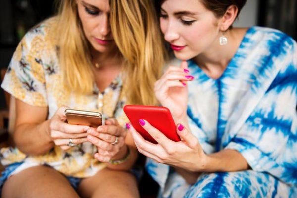 women texting on phone