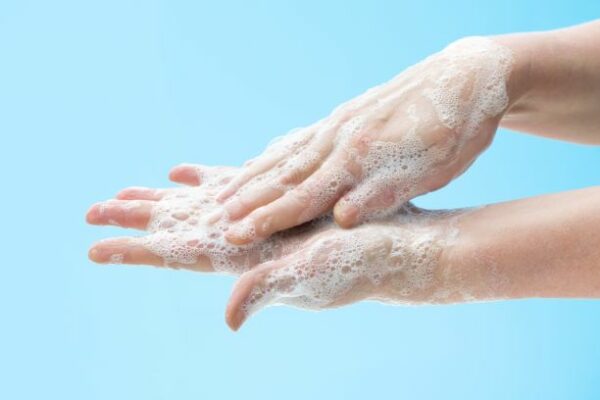 a person washing hands with soap