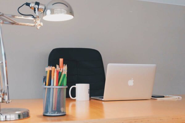 a mac book on an organised table