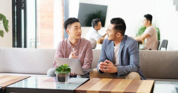 Two business men talking to each other in a lounge area
