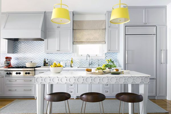 a stunning modern white kitchen with yellow lamps