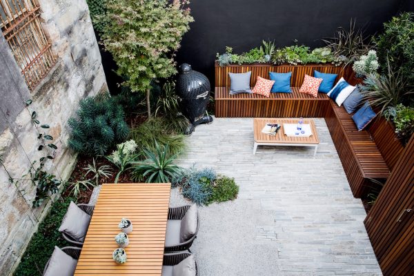 a stunning outdoor space with wooden benches and plants