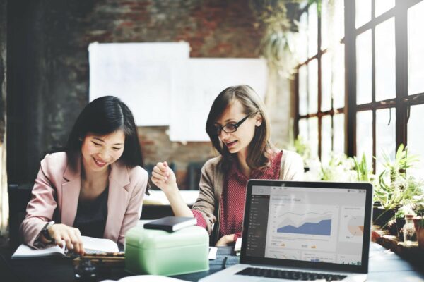 two women working together in the office