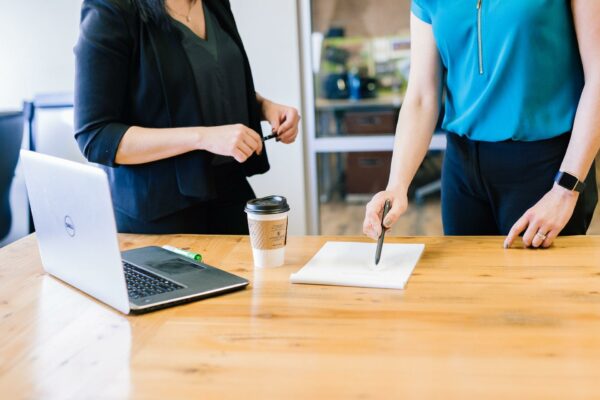 Two women in the office talkig to each other