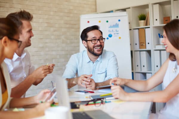 A happy team of co-workers having a discussion