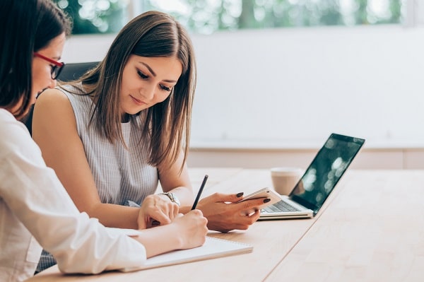 Two women working together