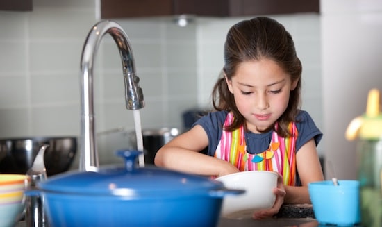 child washing dishes
