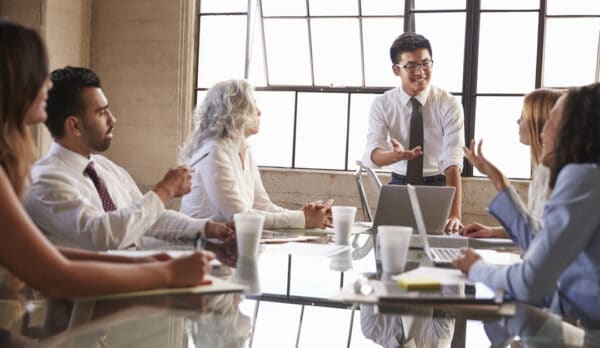 asian businessman addressing colleagues in meeting