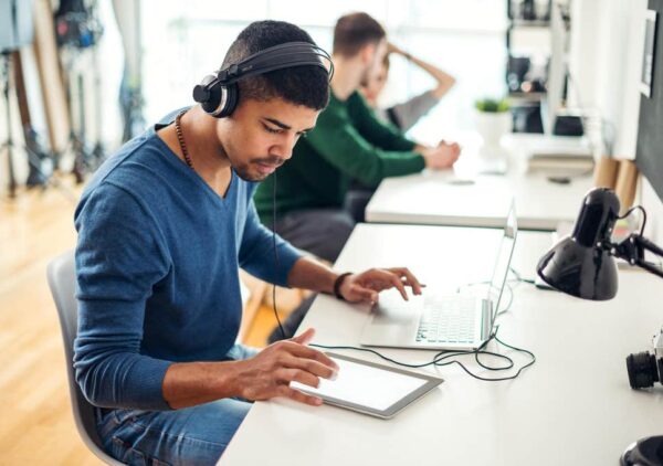 a man listening to music with his headphones while working