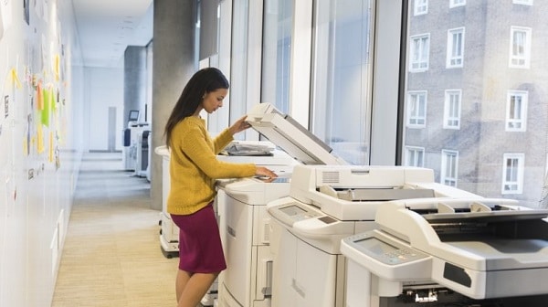 A business woman using a printer