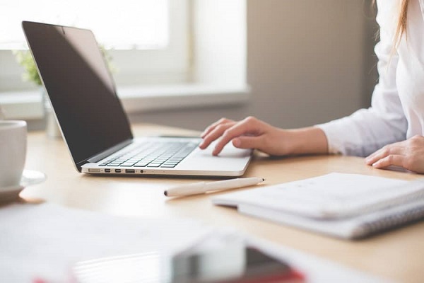 A woman using a laptop to work