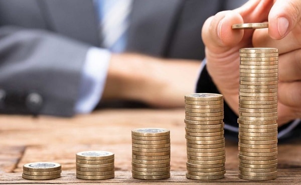 A business man stacking up coins