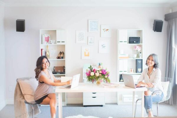 two asian women working in one office