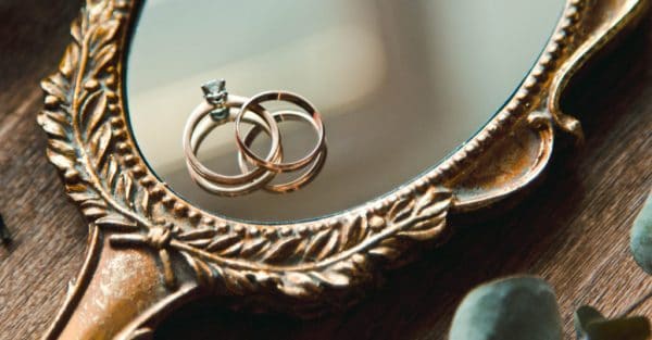 two rings placed on an antique mirror