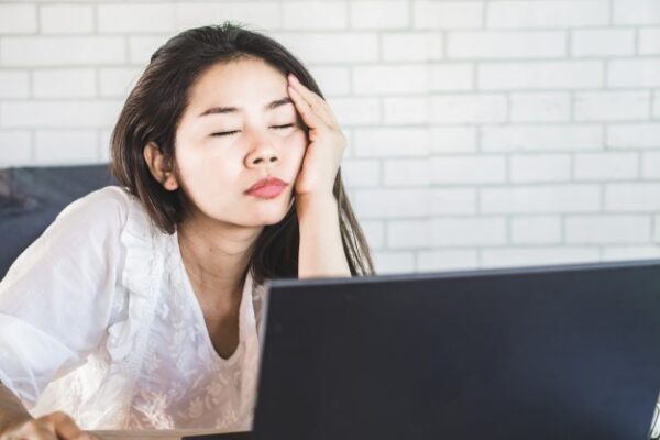 An asian woman sleeping on her office desk